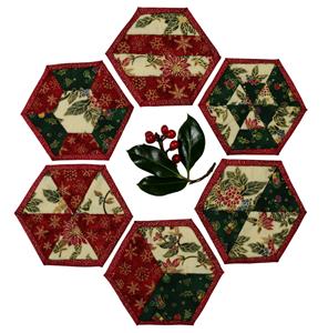 Six very seasonal Christmas coasters in red, green and cream material with a sprig of holly.