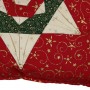 A detail showing one corner, and two points of the six pointed star on the folded star cushion cover.