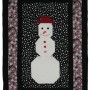 The Snowman panel with the white snowman at the centre surrounded by a black and red border.